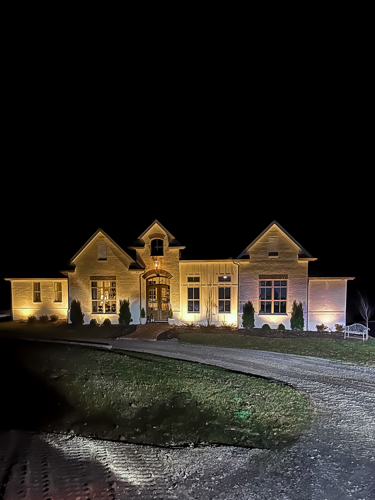 Professional outdoor landscape lighting installation illuminating Tennessee home and garden at night