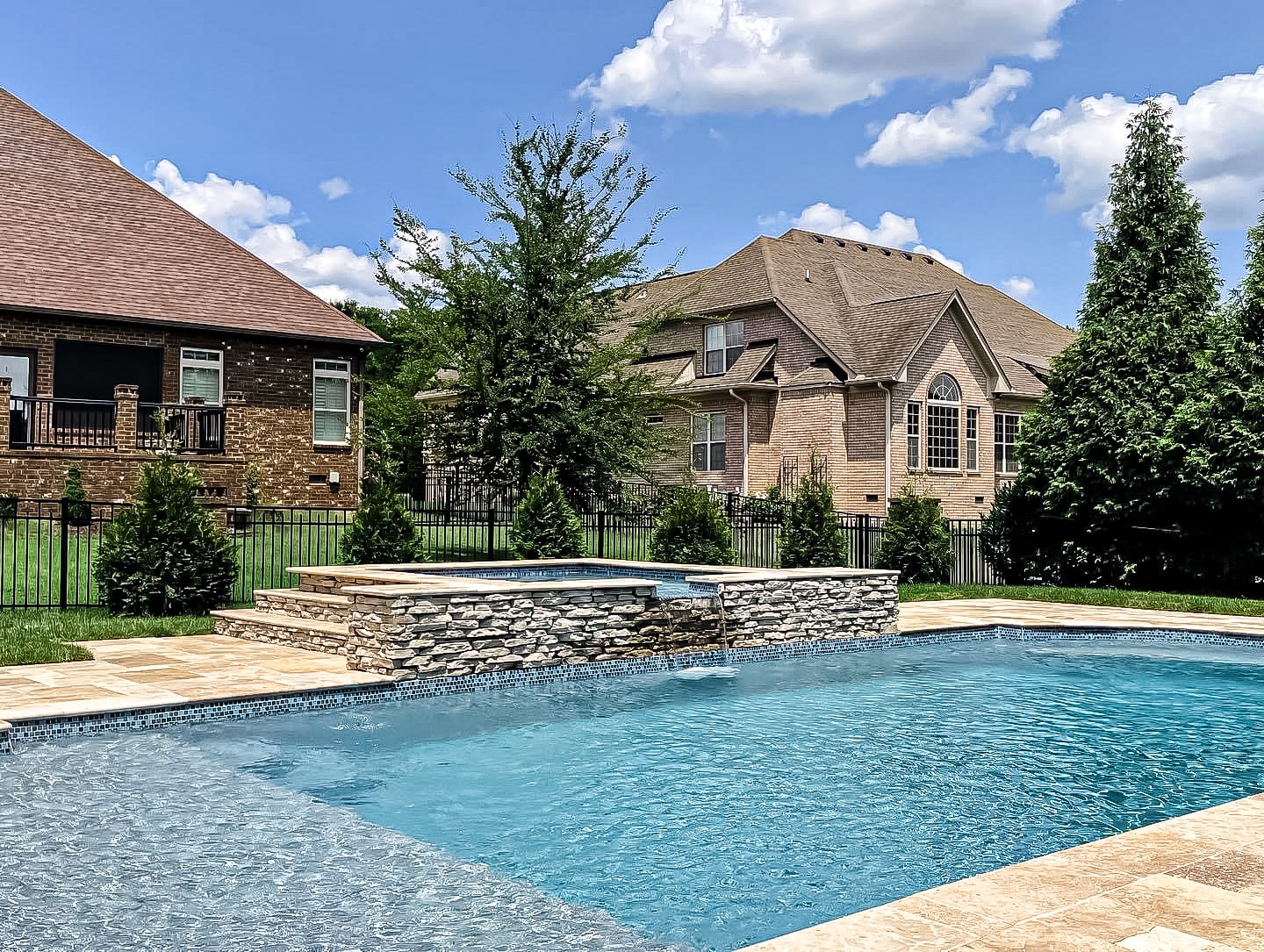 Luxury outdoor living space with water features at Tennessee home by Prestige Landscape