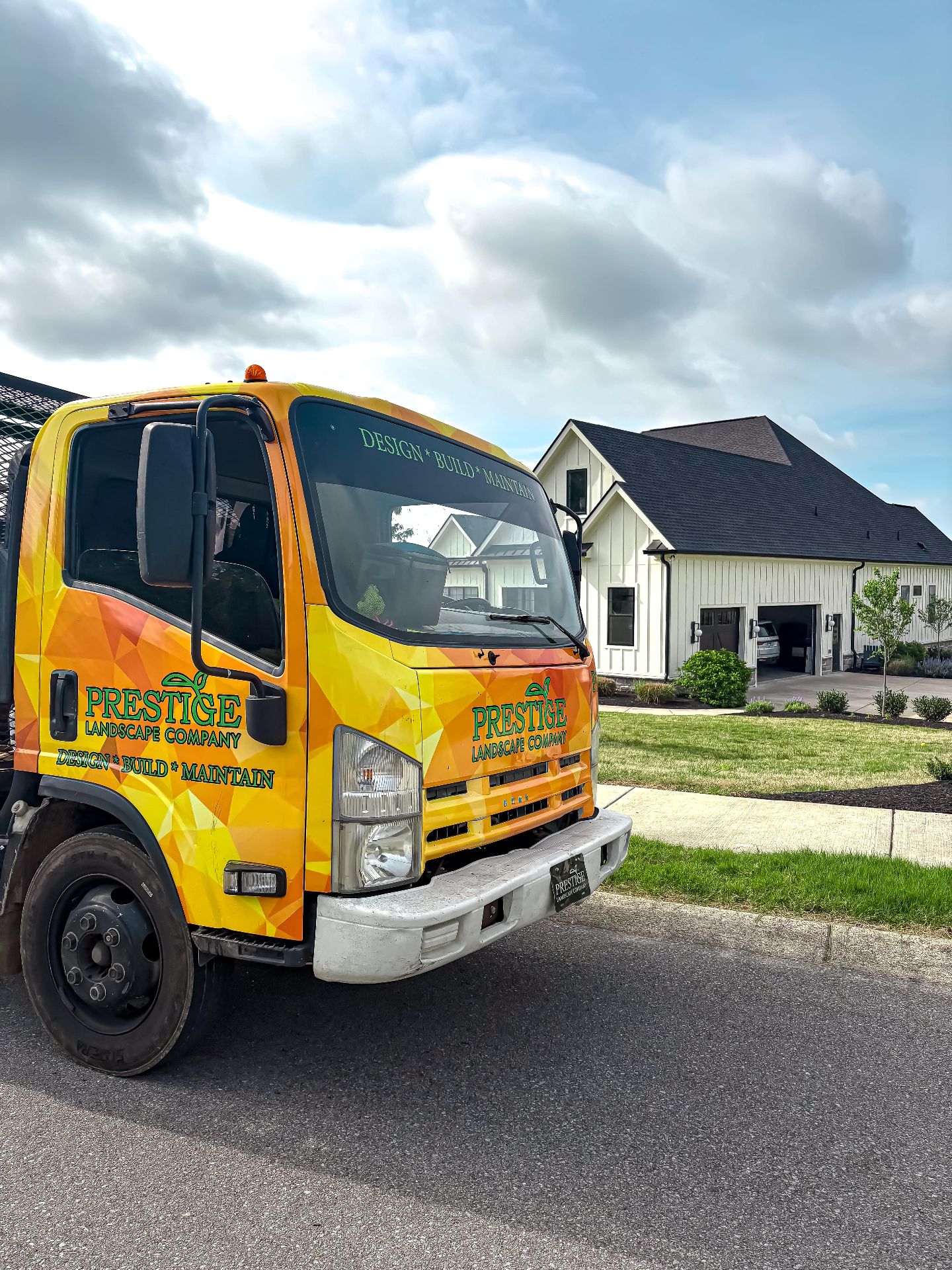 Prestige Landscape Company branded truck arriving at Tennessee residential landscaping job site